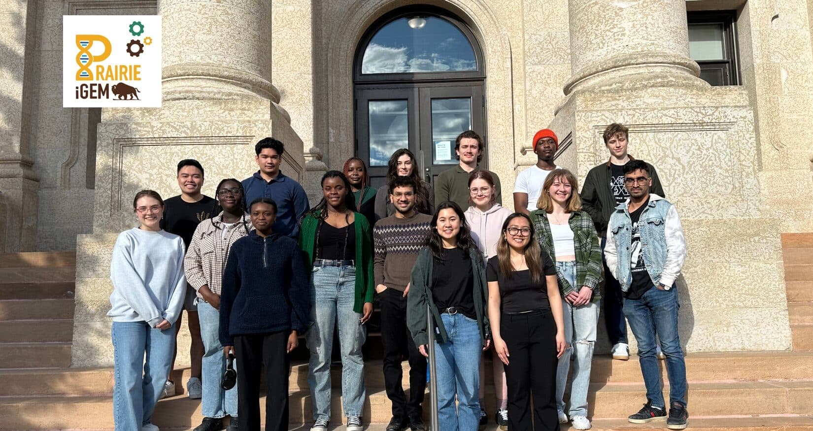 Prairie iGEM students standing together outside on campus steps.